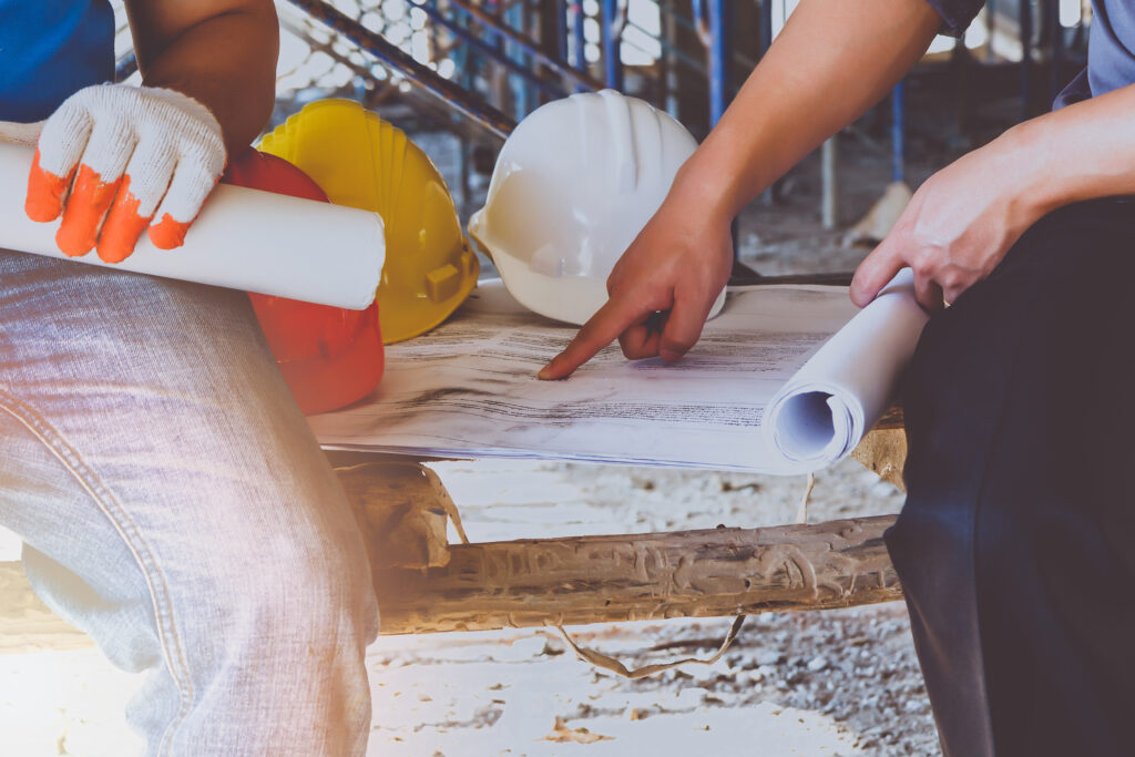 engineer discussing with foreman about project in building construction site